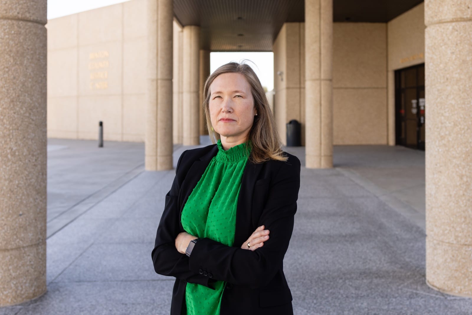 Karla Carlisle, a managing attorney with the nonprofit legal aid program Northwest Justice Project, stands outside the Benton County Justice Center in Kennewick, Wash. Some judicial officers in Washington state, including Benton County, stopped ordering alleged domestic abusers to surrender their guns following a 2022 Washington State Court of Appeals decision. Carlisle hopes that a Court of Appeals ruling issued on June 30 will change that. (Emree Weaver/InvestigateWest)