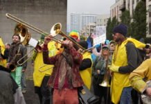 Federal judge extends order barring Trump from sending any National Guard troops to Portland A band plays at a protests at the Immigration and Customs Enforcement facility south of downtown Portland on Sunday