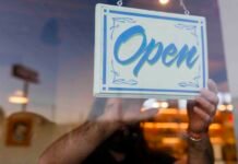 Washington’s employers are carrying too much of the load Open Sign on Door