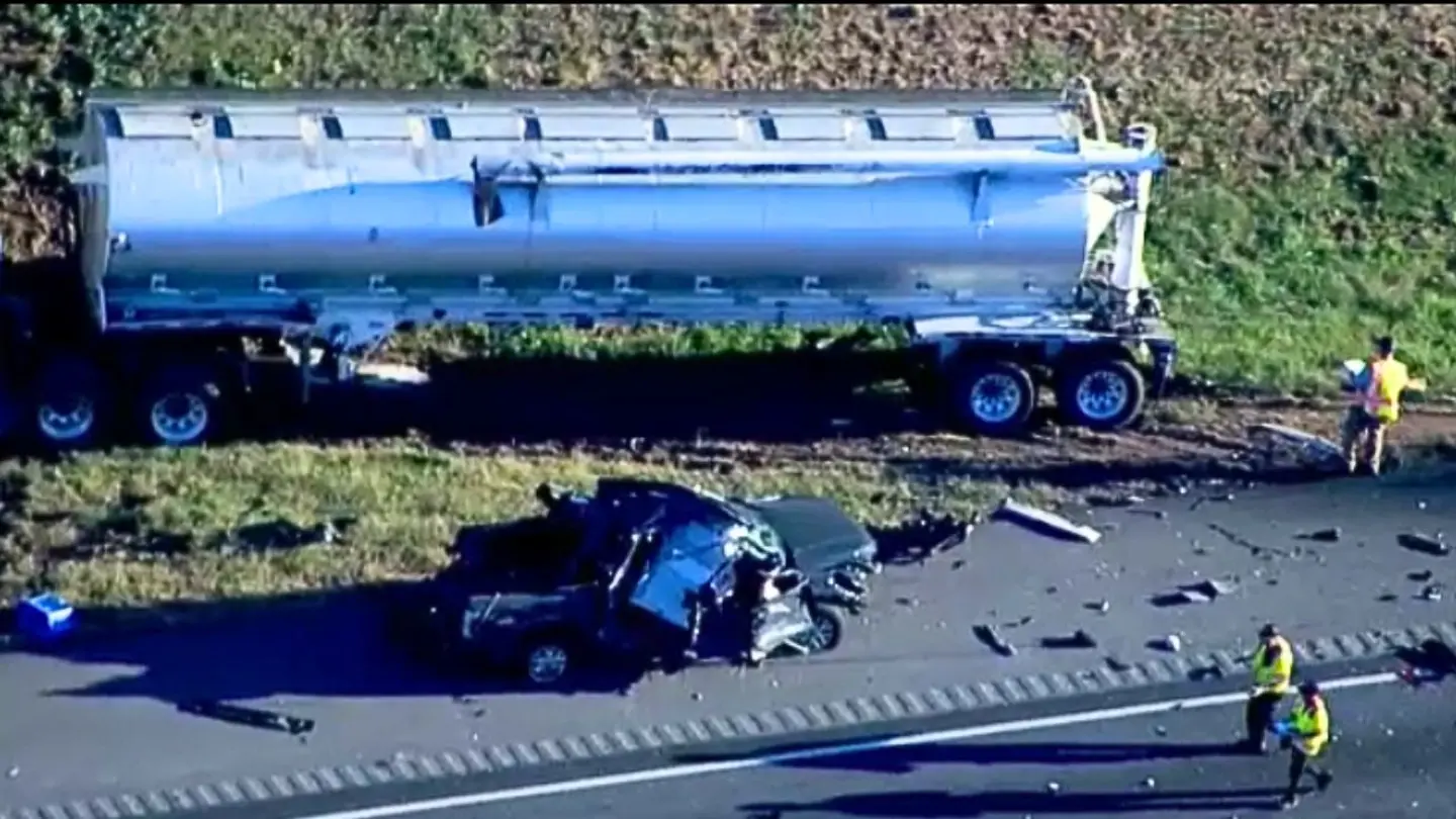 A damaged vehicle is seen near a semi-truck after a fiery crash on Interstate 85 in Jackson County, Georgia, that killed eight people, officials said.