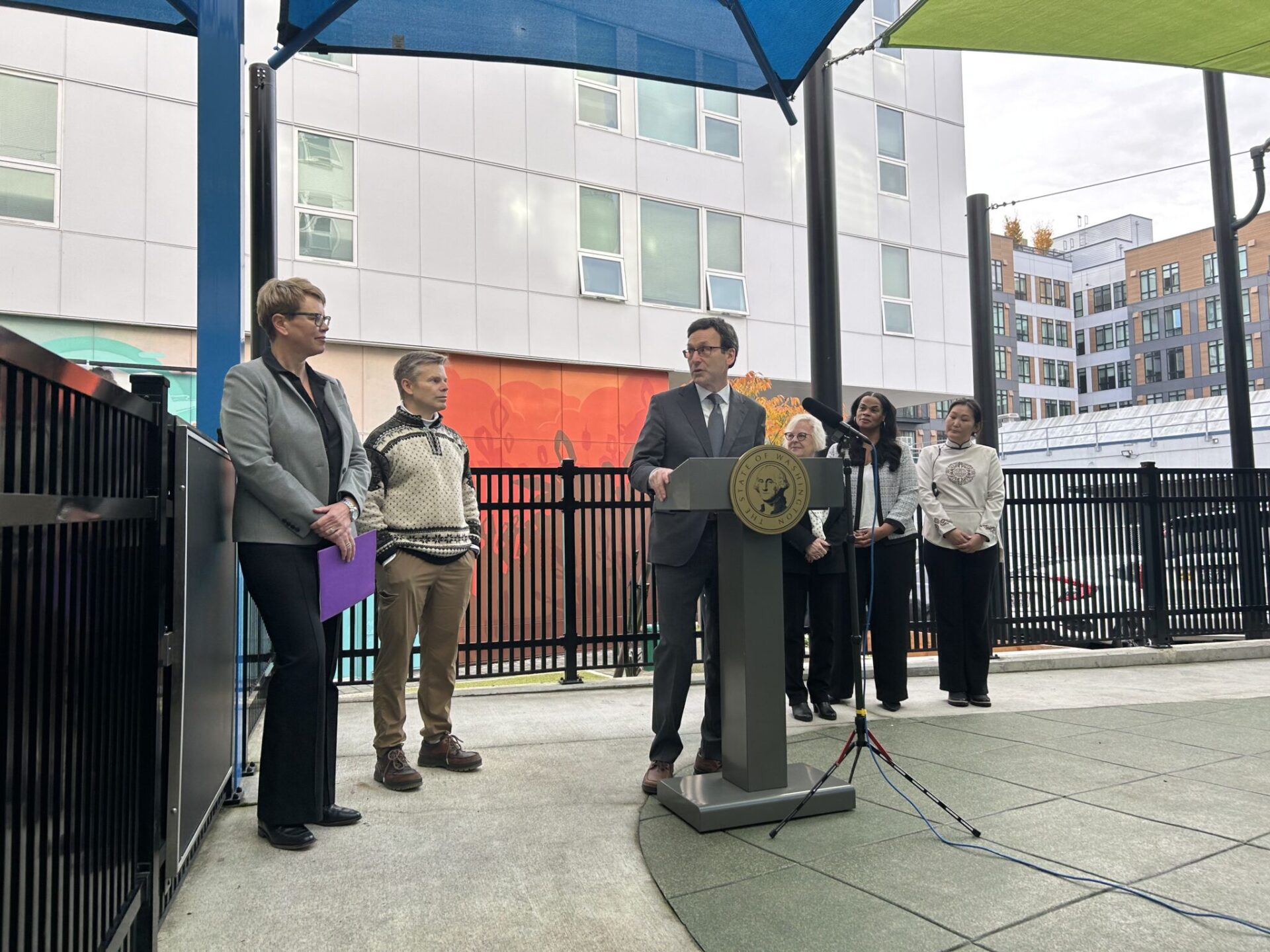 Washington Gov. Bob Ferguson speaks to Andi Smith of the Ballmer Group after the announcement of a major new philanthropic donation to fund early childhood education on Wednesday, Nov. 12, 2025, at the Denise Louie Education Center in Seattle, Washington