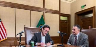 Gov. Bob Ferguson signs documents on Tuesday, Dec. 2, 2025 certifying the results of Washington’s 2025 general election.
