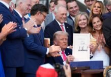 Deportations, tariffs, court clashes, record shutdown mark a historic year in Washington, D.C. President Donald Trump holds up the “One, Big Beautiful Bill” Act that he signed into law on the South Lawn of the White House on July 4, 2025, in Washington, D.C