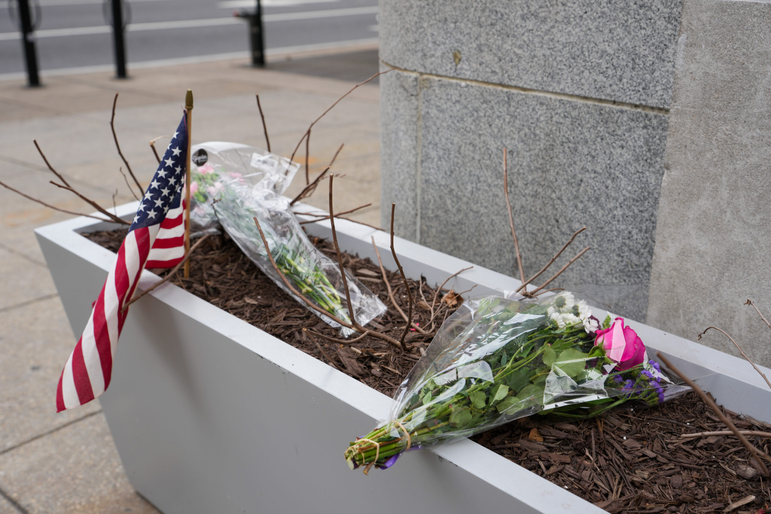 A small memorial of flowers and an American flag has been set up outside the Farragut West Metro station  in Washington, D.C., on Nov. 27, 2025. Two members of the West Virginia National Guard were shot a day earlier in what authorities called a targeted shooting. (Photo by Andrew Leyden/Getty Images)