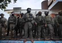 Federal agents, including members of the Department of Homeland Security, and the Border Patrol, hold back protesters outside a downtown U.S. Immigration and Customs Enforcement (ICE) facility on October 03, 2025 in Portland, Oregon