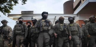 Federal agents, including members of the Department of Homeland Security, and the Border Patrol, hold back protesters outside a downtown U.S. Immigration and Customs Enforcement (ICE) facility on October 03, 2025 in Portland, Oregon