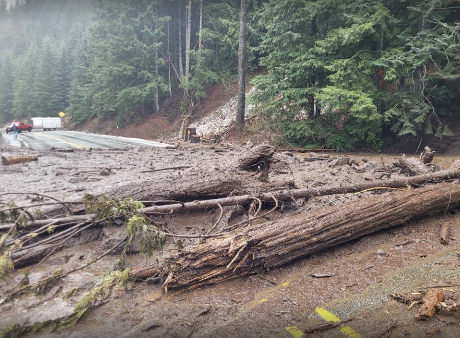 Mud and debris spread across Highway 2. The road closed on Wednesday. Crews are planning to reassess conditions on Thursday. (Photo courtesy of WSDOT)