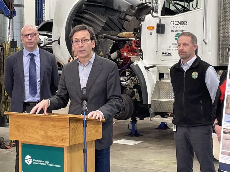 Washington Gov. Bob Ferguson on Friday Dec. 19, 2025 discusses his budget plan to invest $3 billion in highway preservation, bridge maintenance and ferry building in the next decade. The news conference took place at the state Department of Transportation facility in Lacey, Washington. (Photo by Jerry Cornfield/Washington State Standard)