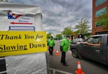 Federal judge blocks Trump election order, siding with Oregon, Washington Jeff Ogg receives a ballot on Monday, May 16, 2022, at a drive-up Marion County ballot drop site in Salem