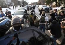 Proposed ban on police face coverings gains momentum in WA Legislature An observer is detained by ICE agents after they arrested two people from a residence on Jan. 13, 2026 in Minneapolis