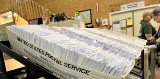 Ballot envelopes sit in the Thurston County elections center