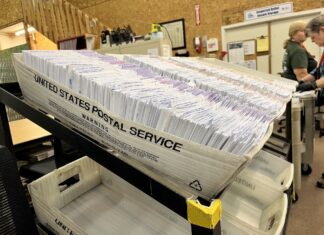 Ballot envelopes sit in the Thurston County elections center
