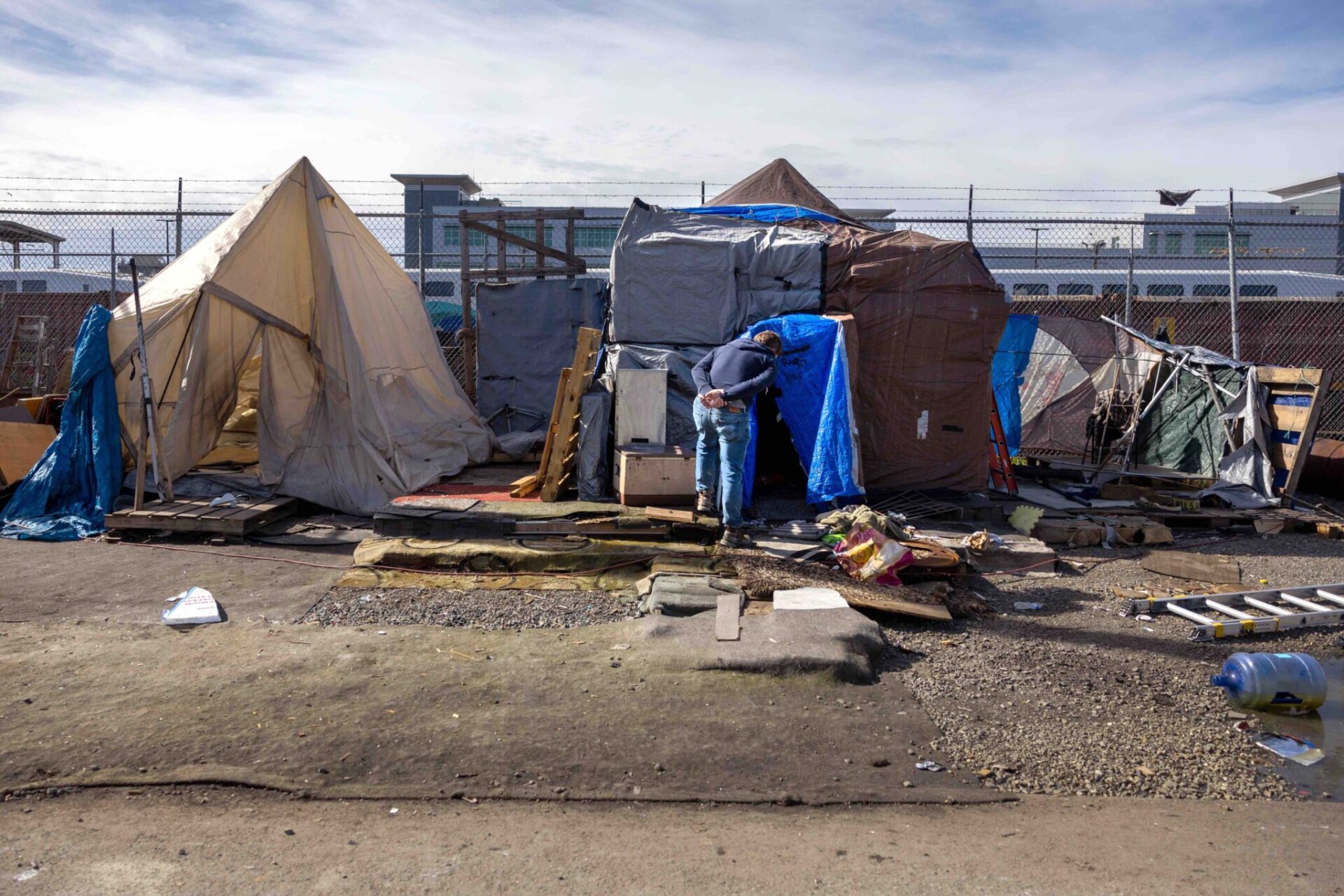 An outreach worker visits an encampment in Seattle in 2022