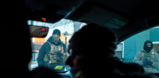 Three cars filled with federal agents stop in front of Elle Neubauer and another observer, surrounding the car and threatening arrest during an early morning watch observing ICE in South Minneapolis Monday, Jan. 12, 2026