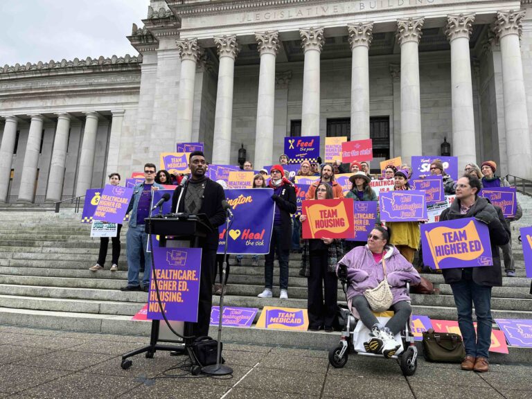 State Rep. Shaun Scott, D-Seattle, authored the amendment to remove a tax break for corporations from the income tax bill. Here he speaks at a December rally at the state Capitol about his proposal for a new payroll tax on larger companies with higher earners. That idea is not moving this legislative session.(Photo by Bill Lucia/Washington State Standard)