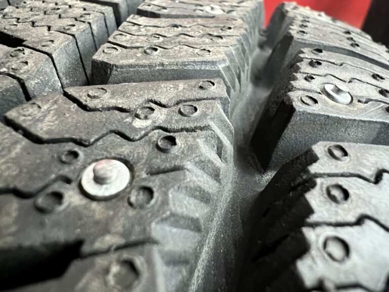 Studded tires have small metal spikes designed to break through snow and ice.