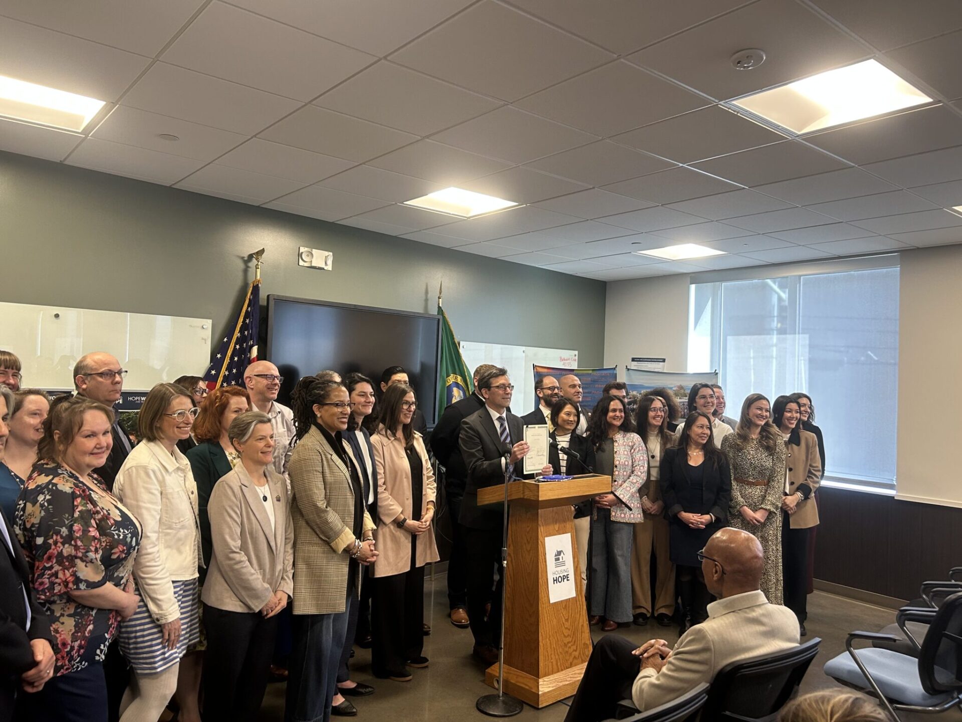Washington Gov. Bob Ferguson stands alongside lawmakers and housing advocates after signing House Bill 2266 into law on Friday, March 27, 2026, in Everett.