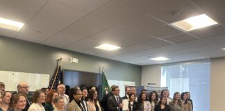 Washington Gov. Bob Ferguson stands alongside lawmakers and housing advocates after signing House Bill 2266 into law on Friday, March 27, 2026, in Everett.