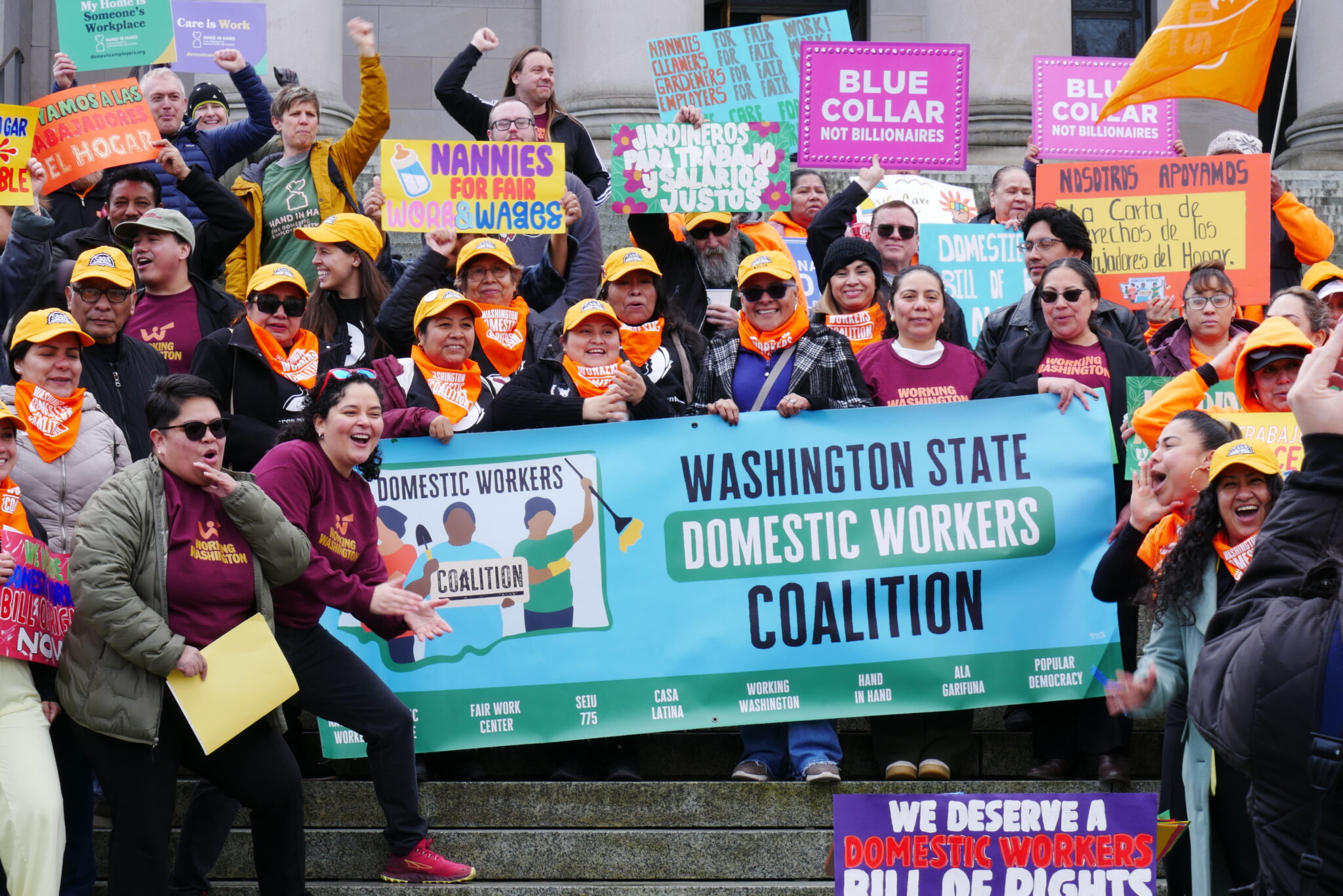 The Washington State Domestic Workers Coalition gather on the state Capitol’s north steps to celebrate the passage of the Domestic Workers Bill of Rights on March 9, 2026. (Aspen Ford/Washington State Standard)