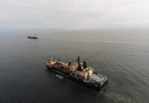 Two dredging vessels, the government-owned Essayons and the Bayport, a contract vessel, at the mount of the Columbia River.