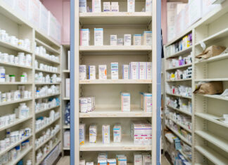 Pharmaceutical giants sue WA over new drug pricing law Medications are stored on shelves at a pharmacy
