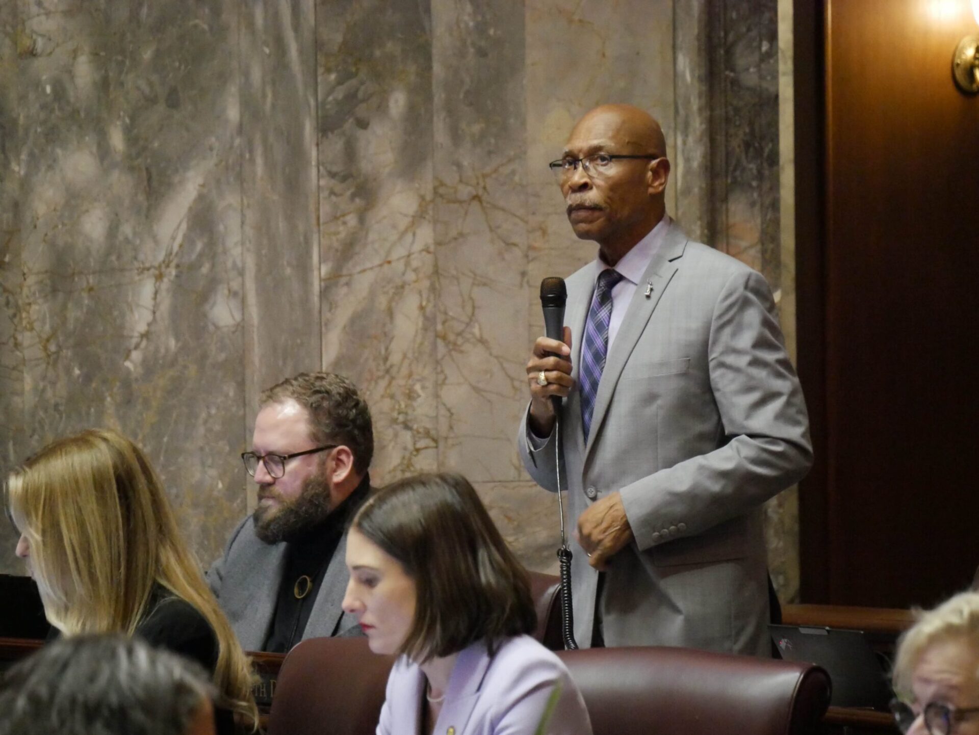 Sen. John Lovick, D-Mill Creek, on the Senate floor on Feb. 12, 2026, prepares to make remarks on his bill to set stricter standards for sheriffs. The legislation was approved, sending it to the House