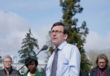 Gov. Bob Ferguson, pictured at a rally after signing the law establishing an income tax on millionaires, is the target of a recall petition for failing to fill vacancies on the commission that enforces state campaign finance laws