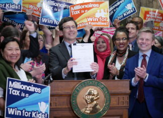 Supporters of Washington’s new income tax on millionaires celebrate after Gov. Bob Ferguson signs the bill into law on Monday March 30, 2026