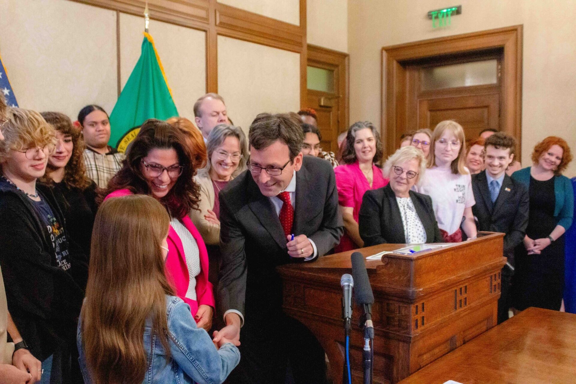 Gov. Bob Ferguson hands over one of the pens he used to sign House Bill 1296, the ‘students bill of rights’ to a child who attended the bill signing