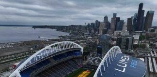 Grass grows beneath lamps during an aerial view of Seattle Stadium on May 6, 2026 in Seattle, Washington. Seattle Stadium, officially named Lumen Field, will host six matches during the 2026 FIFA World Cup.