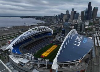 Grass grows beneath lamps during an aerial view of Seattle Stadium on May 6, 2026 in Seattle, Washington. Seattle Stadium, officially named Lumen Field, will host six matches during the 2026 FIFA World Cup.