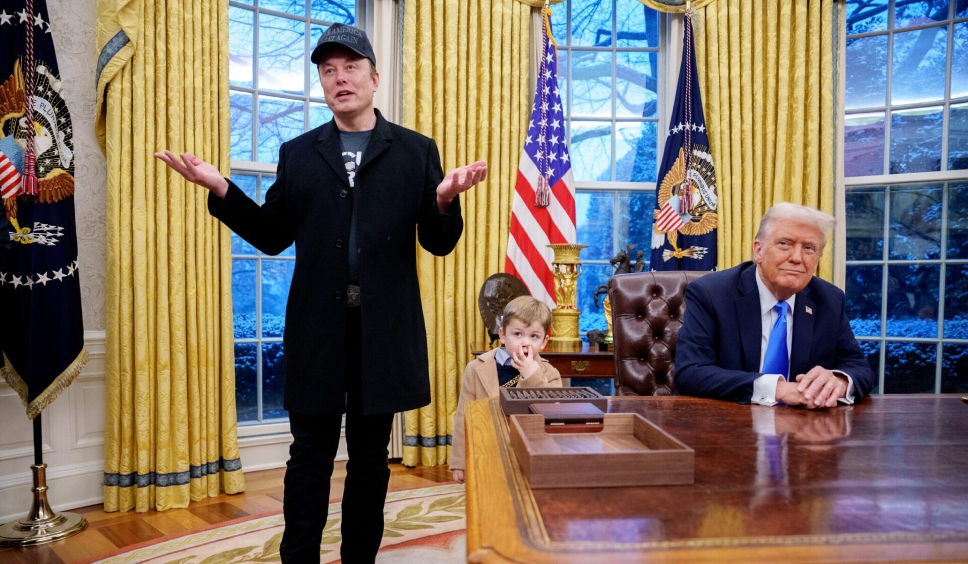 Billionaire Elon Musk, left accompanied by U.S. President Donald Trump, right, and Musk’s son, X Musk, speaks during an executive order signing in the Oval Office at the White House on Feb. 11, 2025 in Washington, D.C.