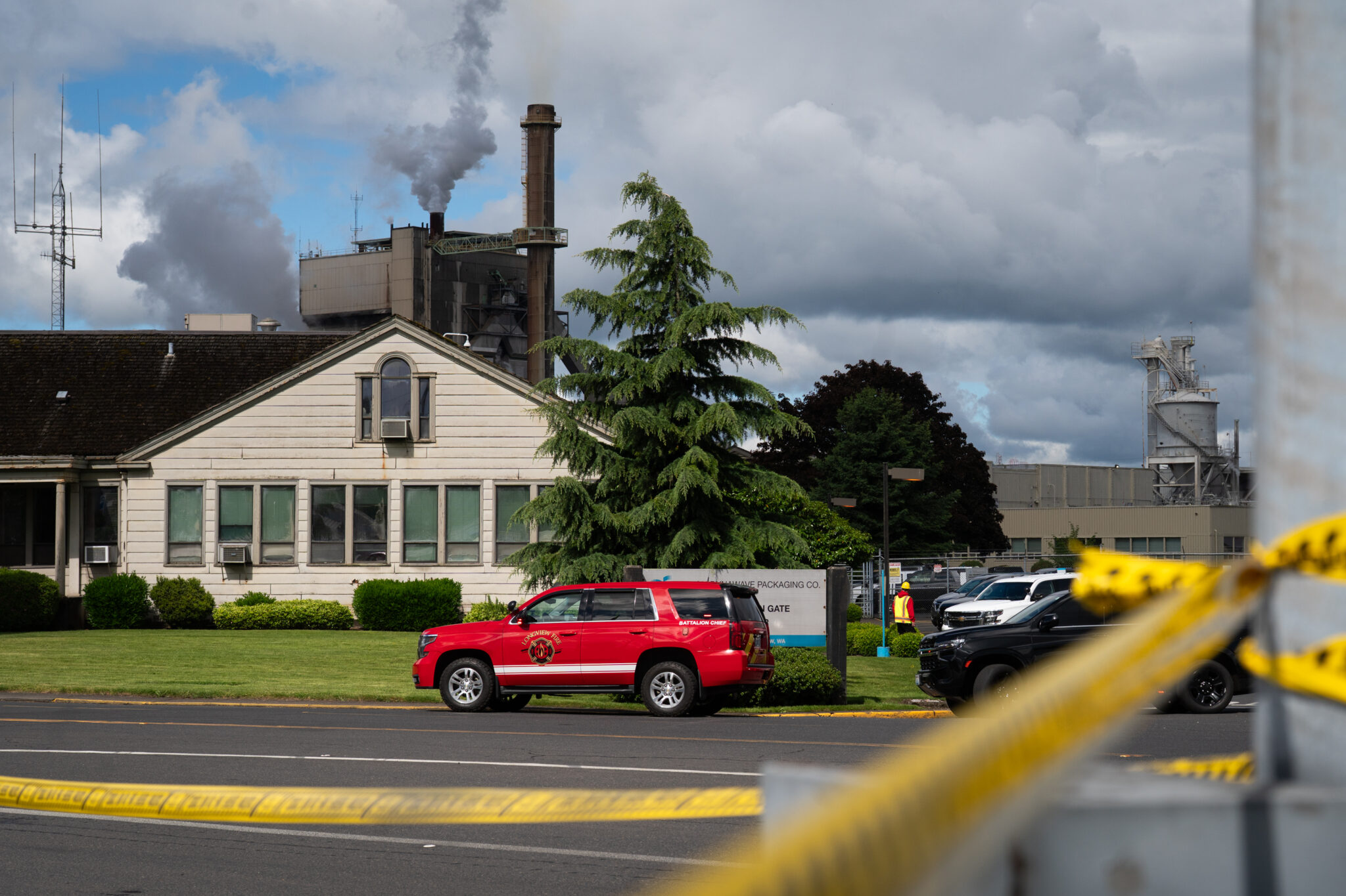 Longview Fire emergency responder vehicles sit parked outside of Nippon Dynawave Packing Company after a chemical implosion early in the morning at the Longview, Wash., facility on May 26, 2026. (Photo by Eli Imadali/Oregon Public Broadcasting)