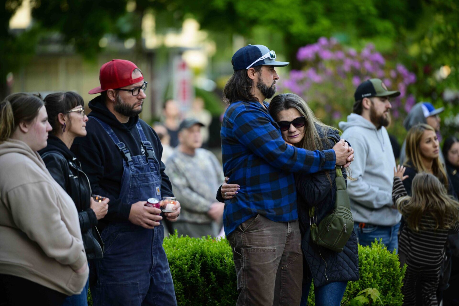 Community members comfort each other during a vigil at R.A. Long Park following a fatal chemical storage tank failure on May 26, 2026 in Longview, Washington.