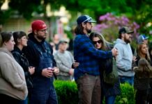 Community members comfort each other during a vigil at R.A. Long Park following a fatal chemical storage tank failure on May 26, 2026 in Longview, Washington.