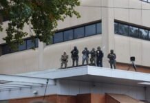 Federal officers shoot pepper balls at protestors at the ICE facility south of downtown Portland on Sunday, Oct. 12, 2025