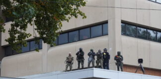 Federal officers shoot pepper balls at protestors at the ICE facility south of downtown Portland on Sunday, Oct. 12, 2025
