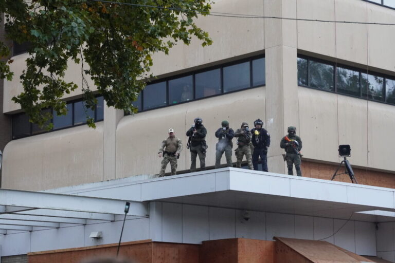 Federal officers shoot pepper balls at protestors at the ICE facility south of downtown Portland on Sunday, Oct. 12, 2025
