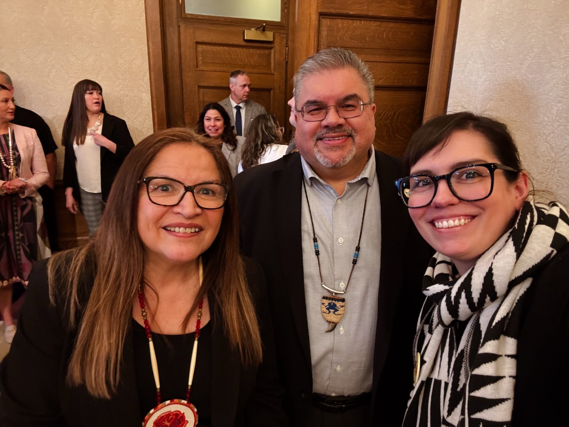 Tim Reynon, center, stepped down as executive director of the Governor's Office of Indian Affairs earlier this month. State Sen. Claudia Kauffman, left, sponsored a new law elevating the office to a cabinet agency for Gov. Bob Ferguson. At right is Jaime Martin, the governor's former external relations director.