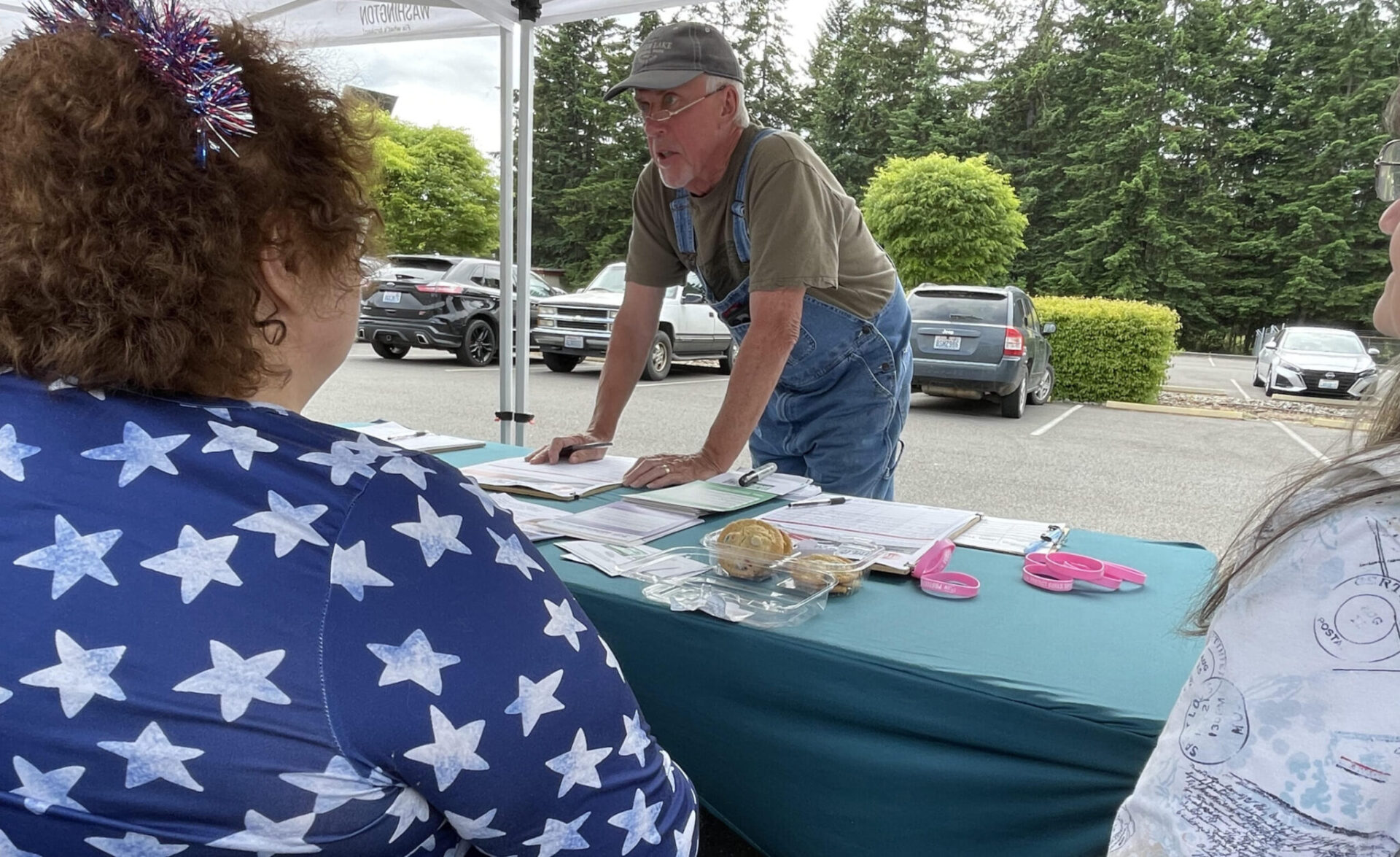 Doug Hicks signs a initiative petition on June 3, 2026 in Tumwater, Washington. The proposed ballot measure would repeal a statewide income tax on high earners enacted earlier this year