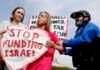 How the Democratic Party’s divide over Israel has reached Washington state A protester against providing U.S. funding to Israel seen during a news conference outside the U.S. Capitol building in 2024. Divisions within the Democratic Party over U.S. support for Israel are increasingly visible in Washington state. (Photo by Anna Moneymaker/Getty Images)