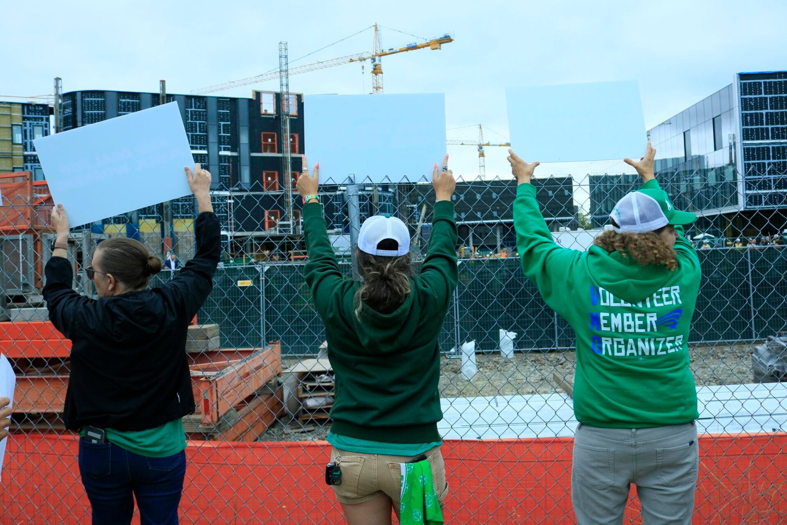 State employees protest near an event commemorating the construction of a new psychiatric facility where Gov. Bob Ferguson was speaking on Aug. 28, 2026. (Photo by Aspen Ford/Washington State Standard)