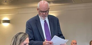Washington state Rep. Tarra Simmons discusses documents with her attorney, Doug McKinley, before testifying at a hearing in June 2026 on allegations she violated state ethics laws. (Photo by Jerry Cornfield/Washington State Standard)
