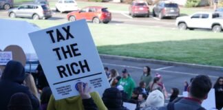 Labor unions and other supporters of an income tax on millionaire earners rallied at the Washington state Capitol in Olympia in February. On this week's edition of "The Impact," representatives for and against repealing the tax made their cases. (Photo by Bill Lucia/Washington State Standard)
