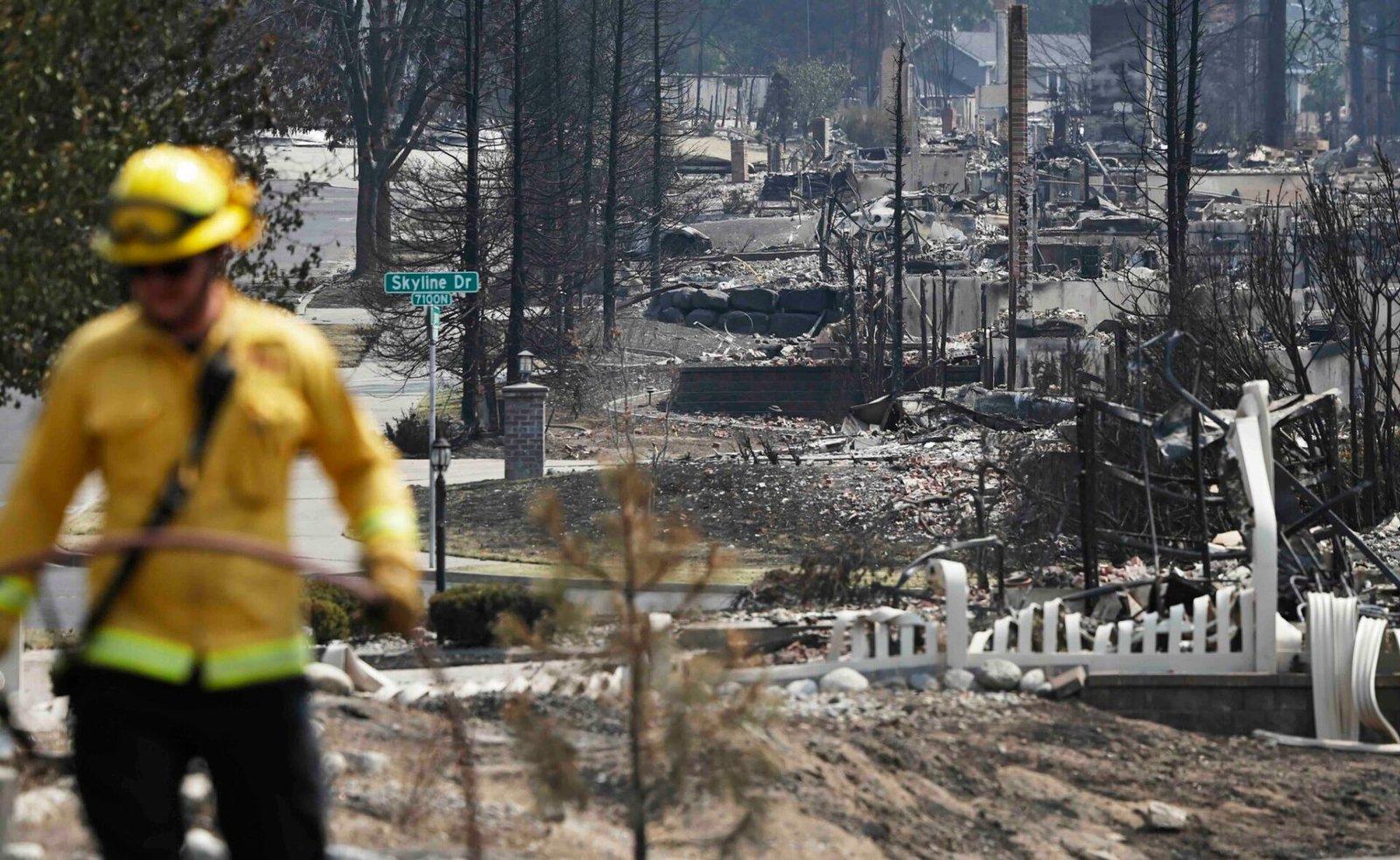 A Cal Fire firefighter works amid the remains of homes destroyed in the Old Trails Fire on Aug. 6, 2026 in Spokane, Washington. (Photo by Mario Tama/Getty Images)