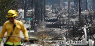 A Cal Fire firefighter works amid the remains of homes destroyed in the Old Trails Fire on Aug. 6, 2026 in Spokane, Washington. (Photo by Mario Tama/Getty Images)
