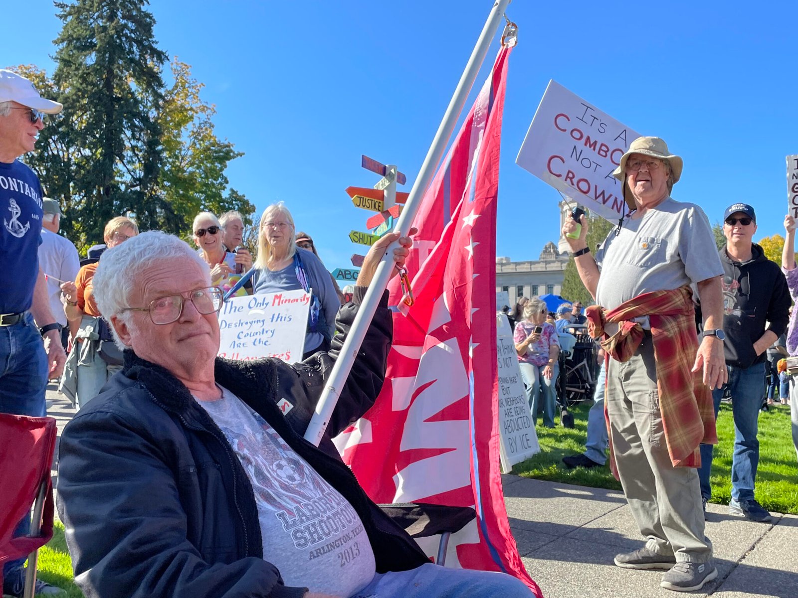 John Hess of Centralia, a supporter of President Donald Trump, endured scornful looks and some abusive language as he sat amongst the crowd at the No Kings rally at the state Capitol in Olympia, Washington, on Oct. 17, 2026. (Photo by Jerry Cornfield/Washington State Standard)